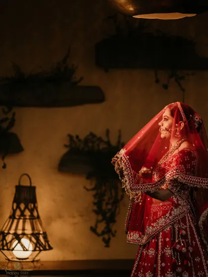 A side profile of the bride under her veil. The warm, soft lighting creates an intimate and timeless bridal portrait.