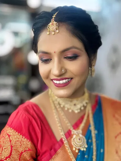 A soft, smiling portrait of the model.