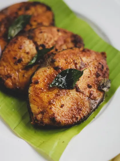 Another shot of the delicious South Indian fried fish, served traditionally on a banana leaf to enhance its aroma.