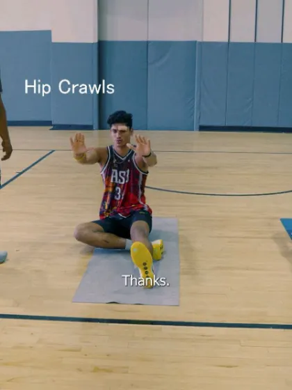 An athlete demonstrates the starting position for hip crawls, an exercise designed to improve hip control and core stability.