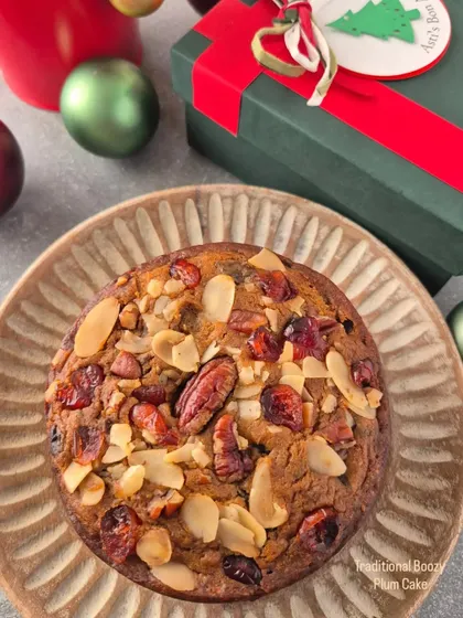 My traditional boozy Plum Cake for Christmas. It's rich, moist, and packed with rum-soaked fruits and nuts like pecans and almonds, presented in a festive gift box.