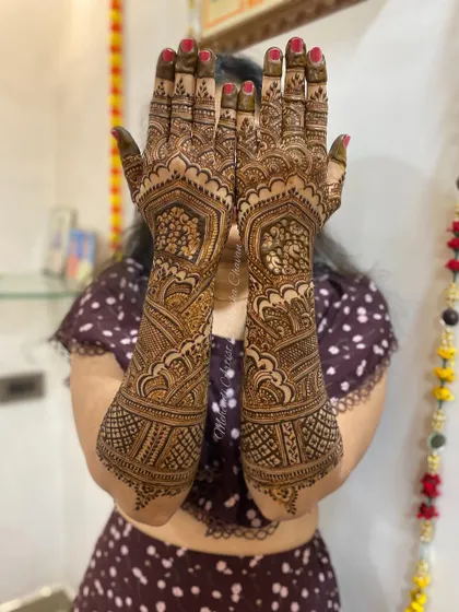 The back of a bridal mehendi design, showing the full coverage and intricate patterns. This is a perfect example of a traditional bridal look.