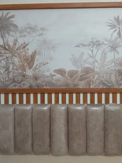 A sepia-toned tropical mural installed above a headboard. The wooden frame gives it a finished look, like a large piece of art, and the muted colors create a calm, vintage feel.