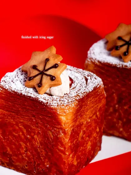 My Spiced Cranberry Croissant Cube is a modern holiday treat. It's filled with winter-spiced cranberry and whipped mascarpone, and topped with a cute gingerbread cookie.