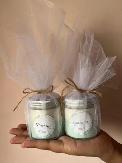 Our silver lid jar candles, wrapped in net with a jute string. They are a perfect, eco-friendly gift.