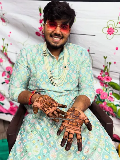 A happy groom ready for his wedding. His hands carry the elegance of peacocks and the strength of elephants, traditional symbols for a new journey.