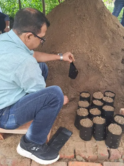 A Valvoline Cummins employee fills a recycled bag with soil, taking an active role in the very first stage of a sapling's life.