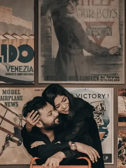 A fun, retro-themed pre-wedding shot. The makeup is classic and timeless, fitting the vintage poster background perfectly.
