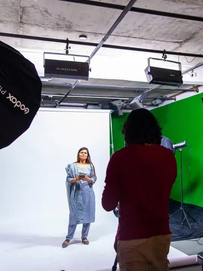Behind the scenes at a studio shoot with a green screen setup. This shows the technical side of creating commercial content for brands.