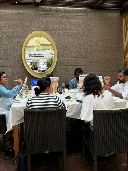 A different angle of the Birkenstock event, showing guests engaged in conversation and painting.