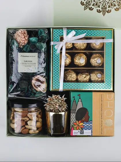 Our "Royal Blend" hamper is a perfect mix of modern and traditional. It combines classic Ferrero Rocher chocolates and dry fruits with fragrant potpourri and Phool incense.