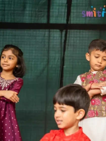 Children in traditional attire perform on stage. Our events often incorporate cultural elements, celebrating our rich heritage.