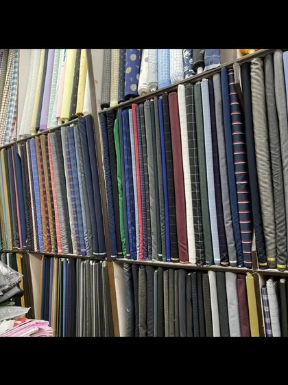 The view inside my shop, with bolts of suiting fabric organized and ready for you to browse. I can help you select the perfect material for your needs.
