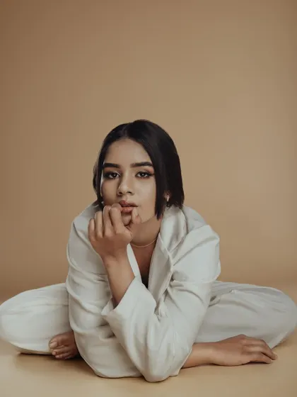 This creative pose and composition highlights the versatility of the makeup. It's a clean canvas that works with artistic and unconventional photography.