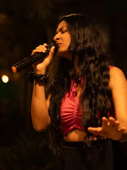 Another angle from a live show, showcasing the dynamic energy of the performance. I use hand gestures and movement to connect with the music and the audience.