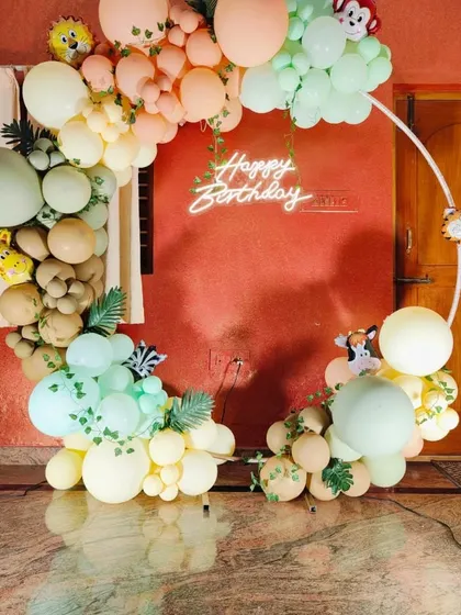 A detailed shot of the balloon arch for the jungle theme, with small animal cutouts and leafy vines.