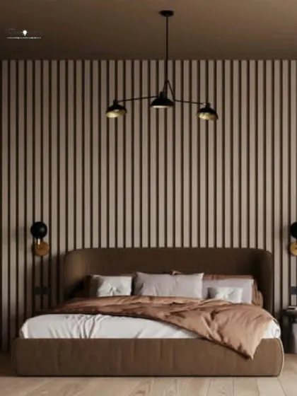 A bedroom design that uses vertical wooden slats as a headboard wall to create texture and warmth. The earthy brown tones and simple pendant lighting result in a calm, contemporary look.
