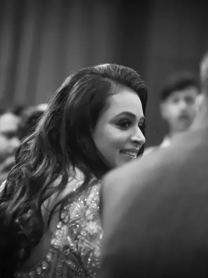 A beautiful black and white candid shot of the bride-to-be. This over-the-shoulder perspective makes it feel like a stolen, intimate moment from the party.