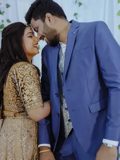 A sweet, candid moment between a couple, their heads close together, sharing a smile.