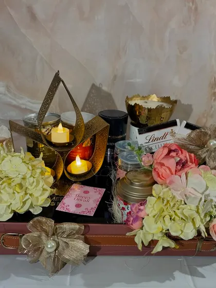 Another angle of the popular Lotus Lit Hamper. You can see the beautiful floral arrangements with hydrangeas and roses that flank the curated selection of gourmet products.