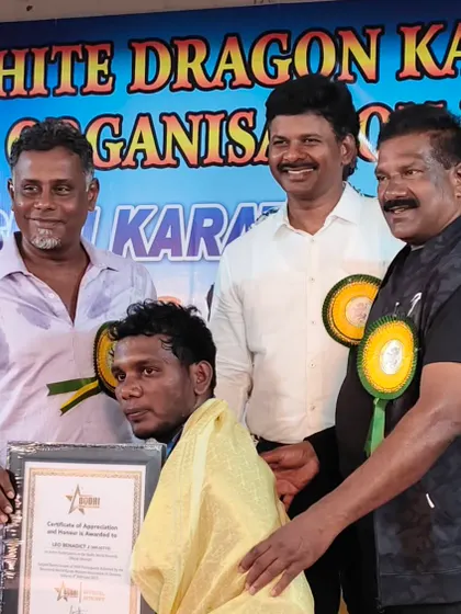 Honoring a fellow master at an award ceremony. The martial arts world is built on a foundation of mutual respect and shared passion for the discipline.