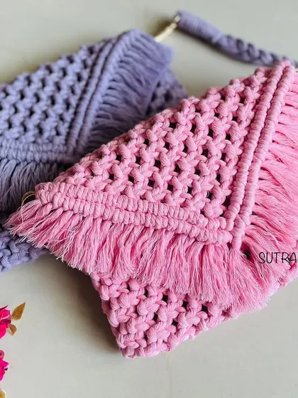 A closer look at the pink and lavender macrame sling bags. You can see the detailed knot work and the soft fringes that give them that perfect boho feel.