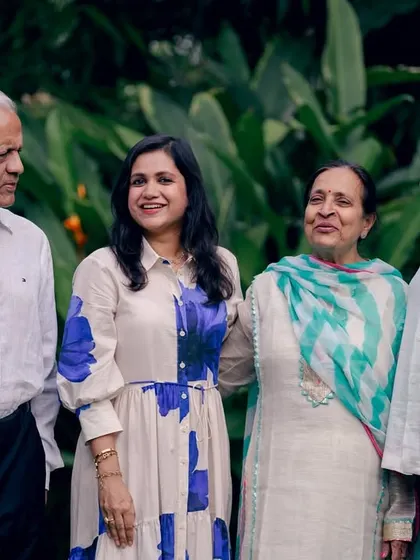 A candid interaction within a multi-generational family portrait, showing the connections and conversations that happen naturally.
