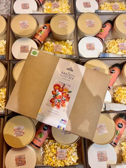I love adding a personal touch. This image shows a custom-themed sleeve being placed on a party box, showcasing how I can tailor the packaging to match your party's theme.