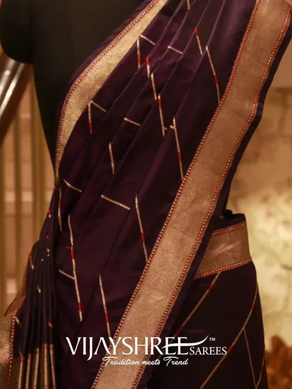 A closer view of the purple Banarasi saree, highlighting its rich color and subtle zari work.