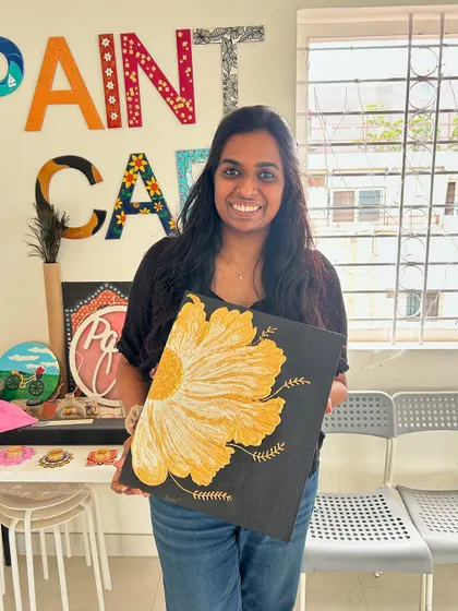 A participant with her stunning large-scale texture art painting of a yellow flower.
