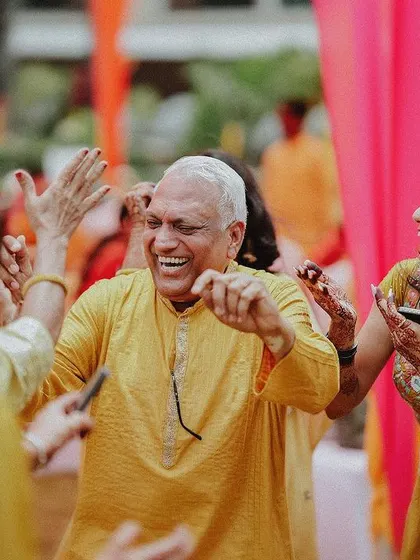 Pure joy on the dance floor as a family member dances with abandon during the Haldi celebration.
