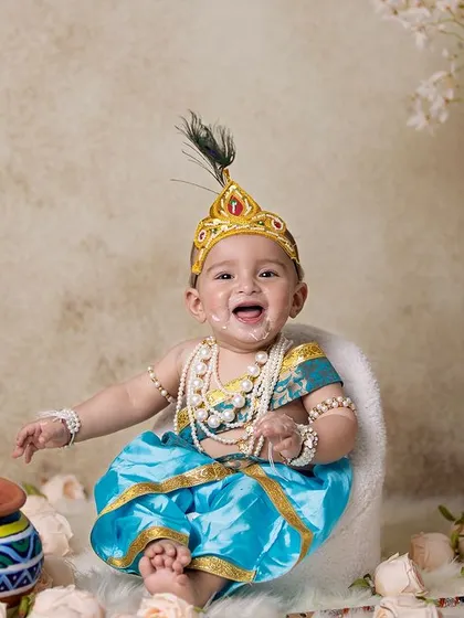 This is a duplicate of image 146. A playful baby Krishna, with a bit of 'butter' on his face, sitting in a chair.