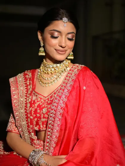 A serene and elegant portrait. The soft makeup and beautiful jewelry create a timeless and classic bridal look.