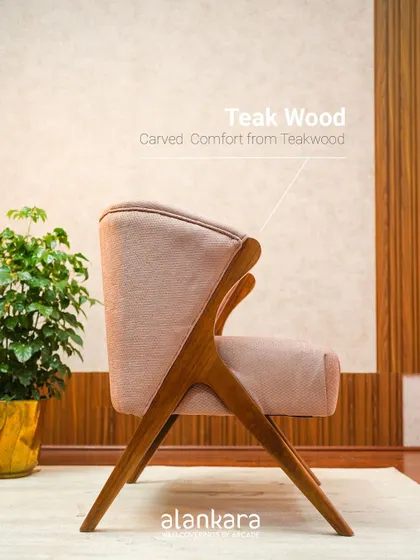 Another side view of the Y-Chair, emphasizing the carved comfort of its teakwood frame.