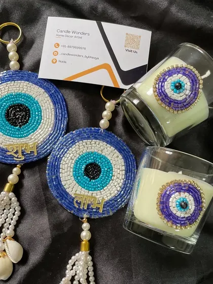 My Evil Eye gift set is a unique and thoughtful hamper. It includes a beaded wall hanging and a matching shot glass candle for good vibes.