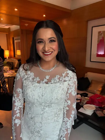 A happy, smiling portrait of the bride Michelle, all set for her Catholic wedding. The makeup is fresh, natural, and glowing.