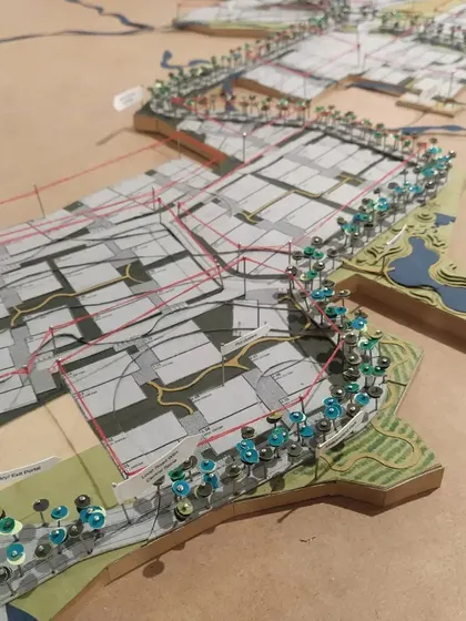 A physical model is a crucial tool in my design process. This concept model for a new master plan uses pins and layered drawings to represent planting strategies, circulation paths, and land use, helping the team and client visualize the project in three dimensions.