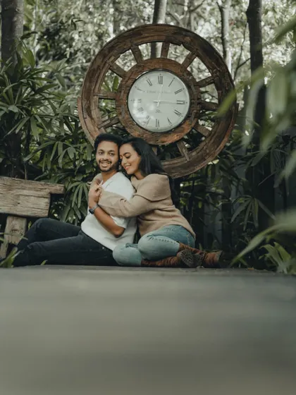 A warm embrace tells a story of comfort and love. This cozy pre-wedding portrait was taken on a wooden deck surrounded by nature.