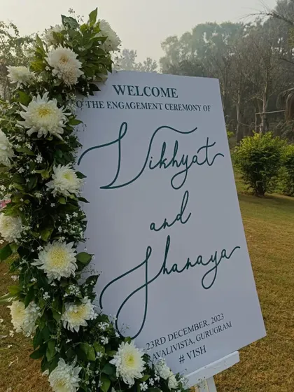 Another angle of the beautiful engagement welcome sign. The clean design and fresh flowers make it a perfect addition to any modern, elegant outdoor event.