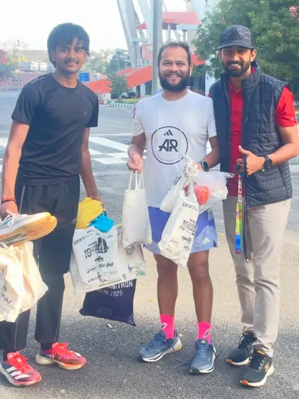 With a fellow coach who helped collect and distribute running gear to young athletes. It takes a community to build champions, and I am grateful for the support.