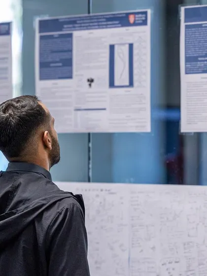 A participant studies research posters displayed at our UKSCA conference. We encourage a deep, evidence-based understanding of sports science principles among all attendees.