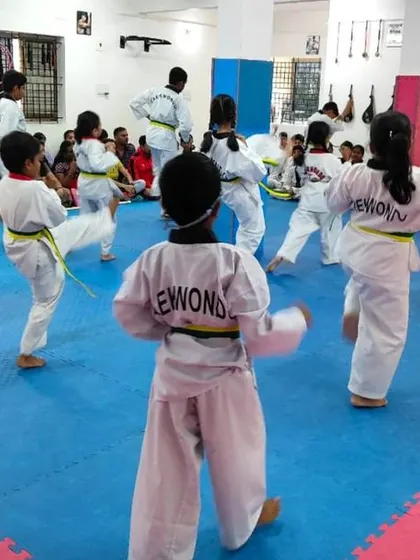 A view from the back of students practicing their kicks.
