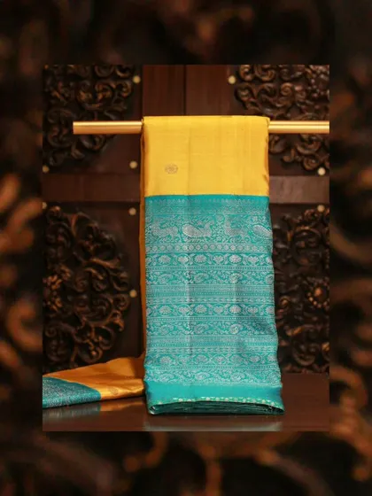A yellow Kanjivaram with a stunning blue brocade border, a classic choice for Day 1 of Navratri.
