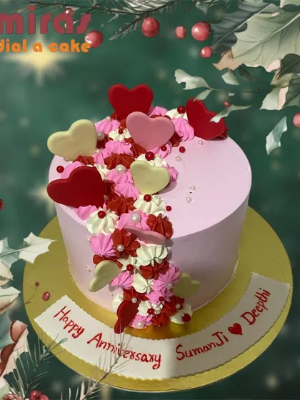 A beautiful anniversary cake with a cascade of red, pink, and white hearts. This design is a vibrant and joyful expression of love.