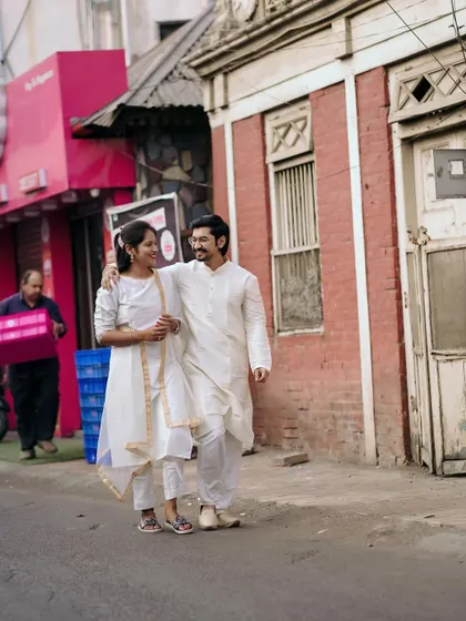 A candid street photography moment, capturing the couple in their own world amidst the hustle and bustle of the city.