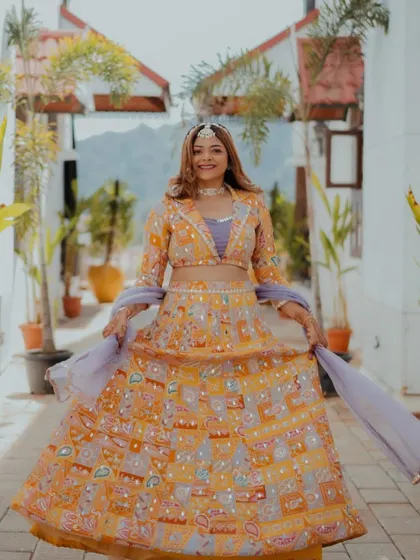 A full-length view of her beautiful and colorful outfit. The soft makeup and hair balance the vibrant lehenga perfectly.