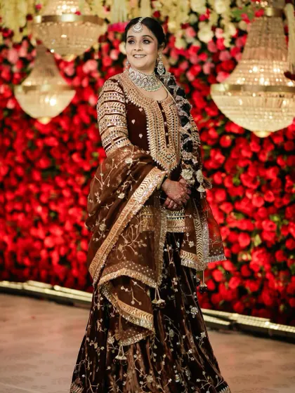 A full-length shot showcasing her stunning royal look. The makeup and hair are styled to perfection, complementing her embroidered velvet outfit.