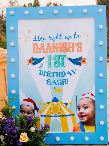 A personalized welcome sign for Daanish's first birthday bash, featuring his adorable photos. The light-up frame adds a touch of sparkle and excitement.