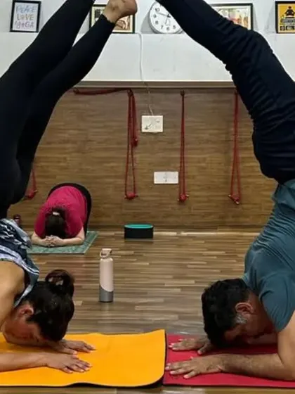 Partner headstands (Sirsasana) help build confidence, improve balance, and create a fun, supportive atmosphere.