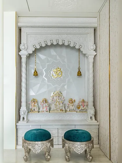 A closer look at the 'Urban Oasis' mandir. The detailed marble carving and the geometric pattern on the back wall create a space that is both traditional and contemporary.